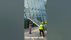 L'équipe d'installation de Sunframe installe un rideau de verre.